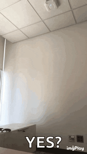 a room with a white ceiling and a yes sign on the wall