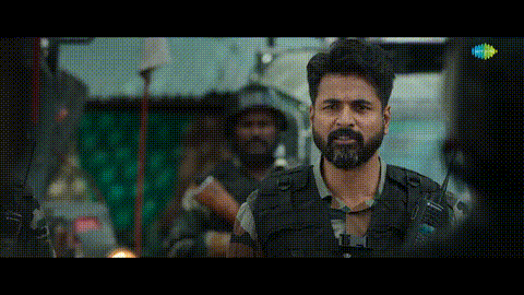 a man with a beard is standing in front of a group of soldiers in a movie .