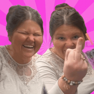 a woman is giving the middle finger while smiling and laughing