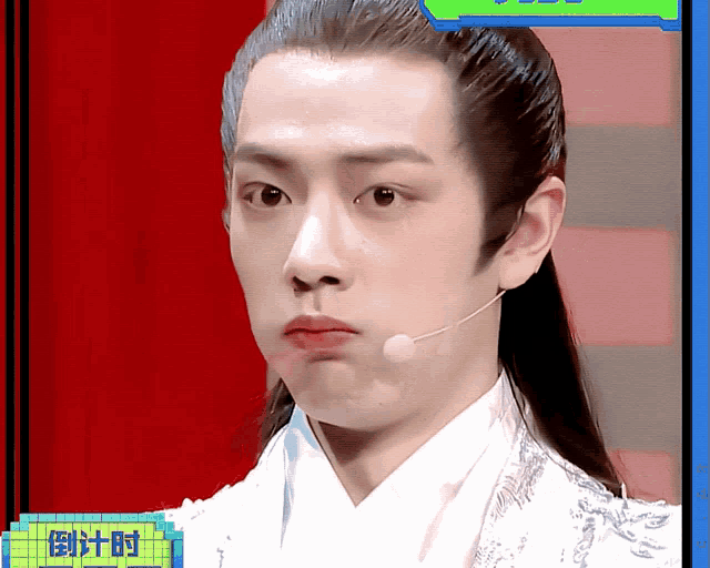 a man wearing a white kimono and a microphone with chinese writing on it