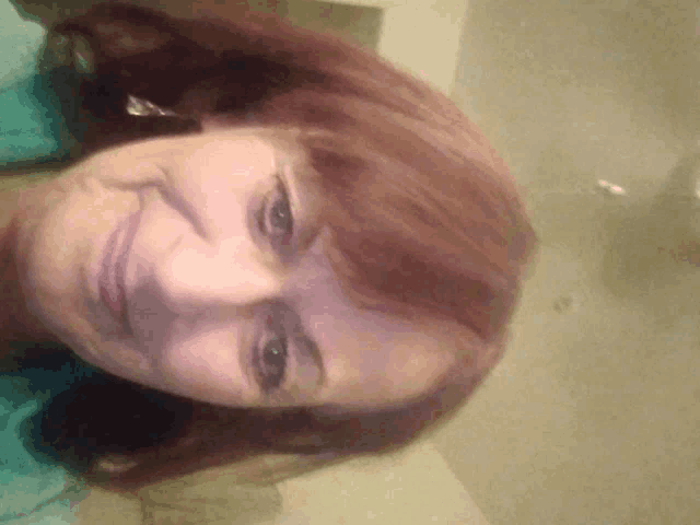a close up of a woman 's face with a smile on her face