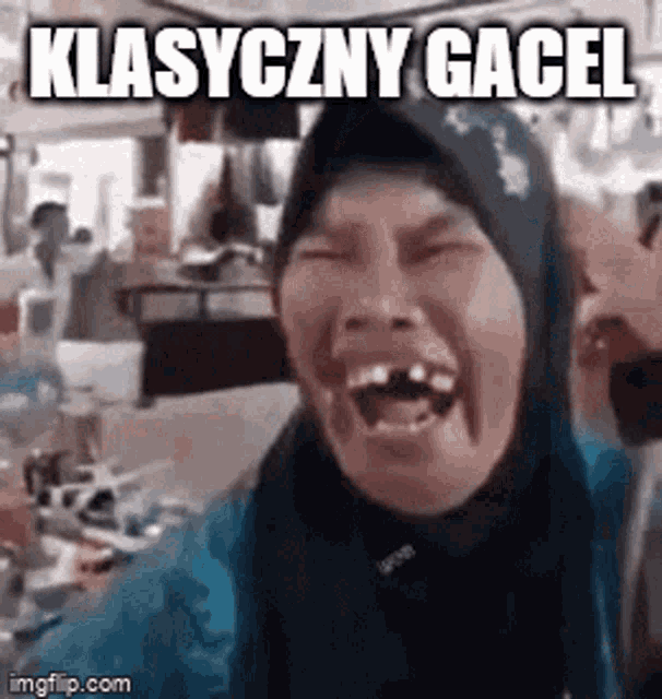 a woman with a hijab on is laughing with her mouth open and the words klasyczny gacel written on the bottom .