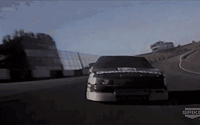 a race car is driving down a track with spike written on the bottom of the screen