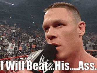 a man speaking into a microphone with the words " i will beat his ass " written below him