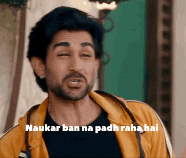 a man with a beard is wearing a yellow jacket with the words " naukar ban na padh raha hai " on it
