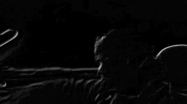 a man is driving a car in the dark