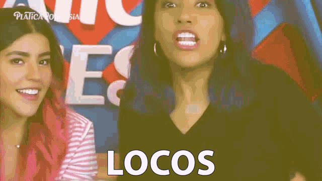 two women are standing next to each other with the word locos written in white