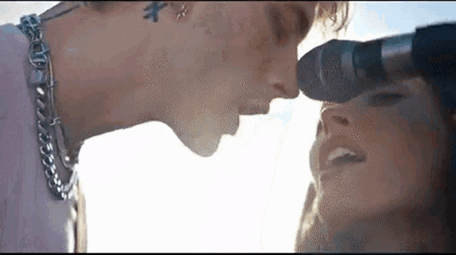 a man and woman are singing into a microphone .