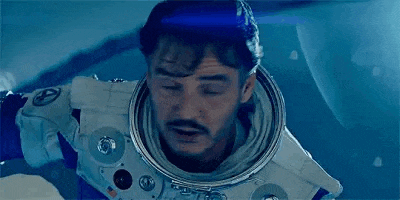 a man in an astronaut 's helmet is flying through the air .