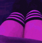 a close up of a person 's legs wearing purple thigh high socks .