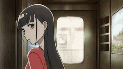 a girl with long black hair is standing in a hallway with a sign on the wall that says ' a '