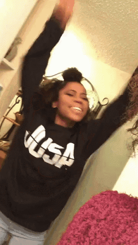 a woman wearing a black sweater with the word usa on it
