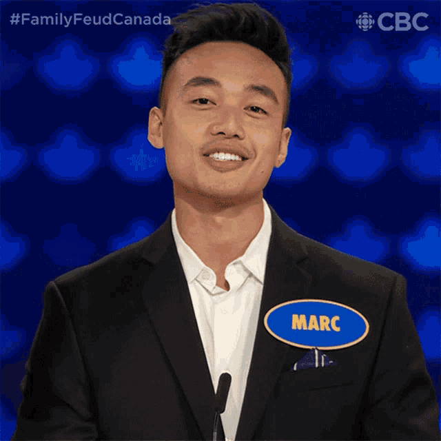 a man in a suit has a name tag that says marc on it