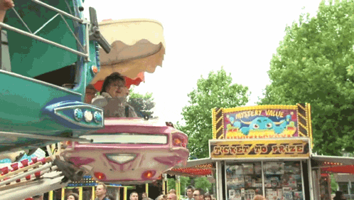 a carnival ride with a sign that says mystery value ticket to prize