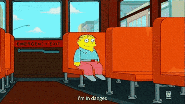 a cartoon of ralph from the simpsons sits in an orange seat