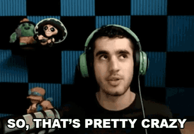 a man wearing headphones is standing in front of a microphone and saying `` so that 's pretty crazy '' .