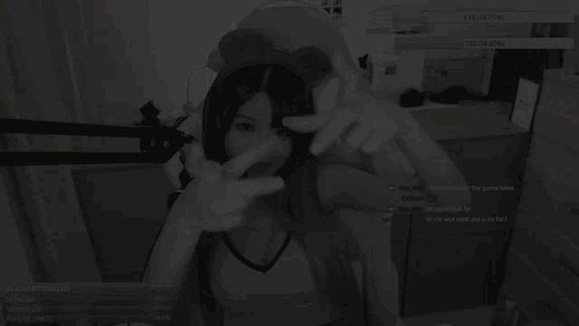 a blurry image of a woman giving a peace sign