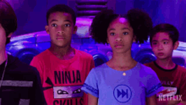 a group of children are standing next to each other in front of a netflix logo .