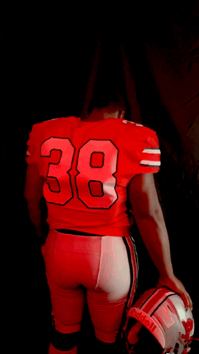 a football player in a red uniform with the number 38