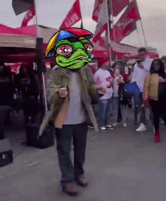a man wearing a frog mask is dancing in front of a crowd of people