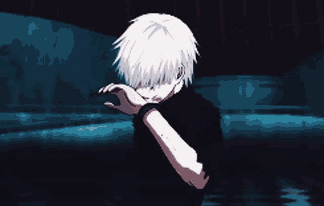 a man with white hair is covering his face with his hand
