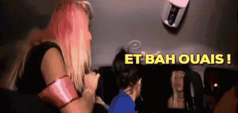 a woman with pink hair is singing into a microphone with the words et bah ouais written in yellow