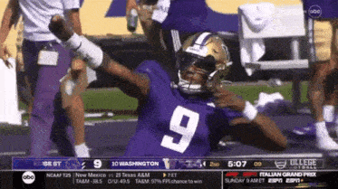 a football player with the number 9 on his jersey is celebrating