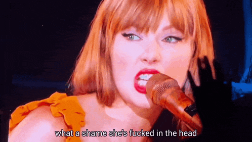 a woman singing into a microphone with the words " what a shame she 's fucked in the head " next to her
