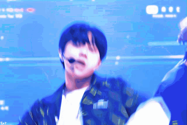 a blurry picture of a man with a microphone in his mouth