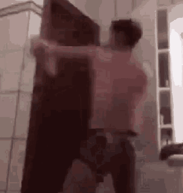 a couple of men are standing next to each other in a bathroom .