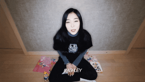 a woman wearing a black shirt that says ashley