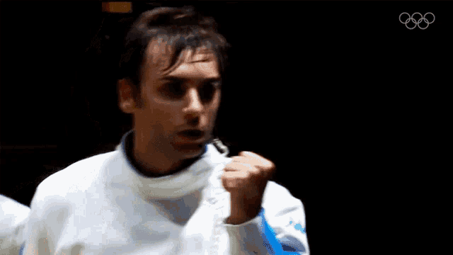 a man wearing a white jacket with the word kappa on the sleeves