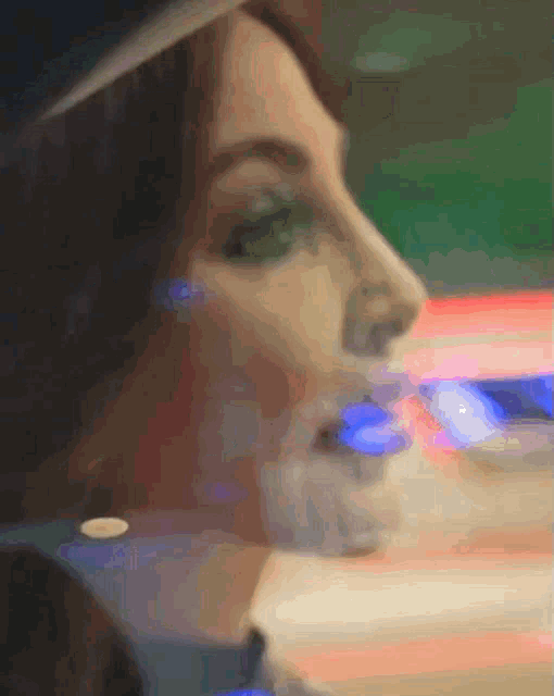 a blurry picture of a woman with green eyes