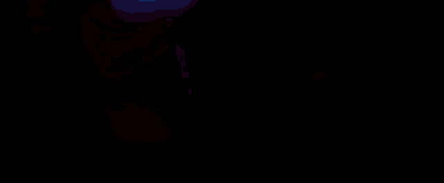 a close up of a man 's face with a red and blue light behind it .