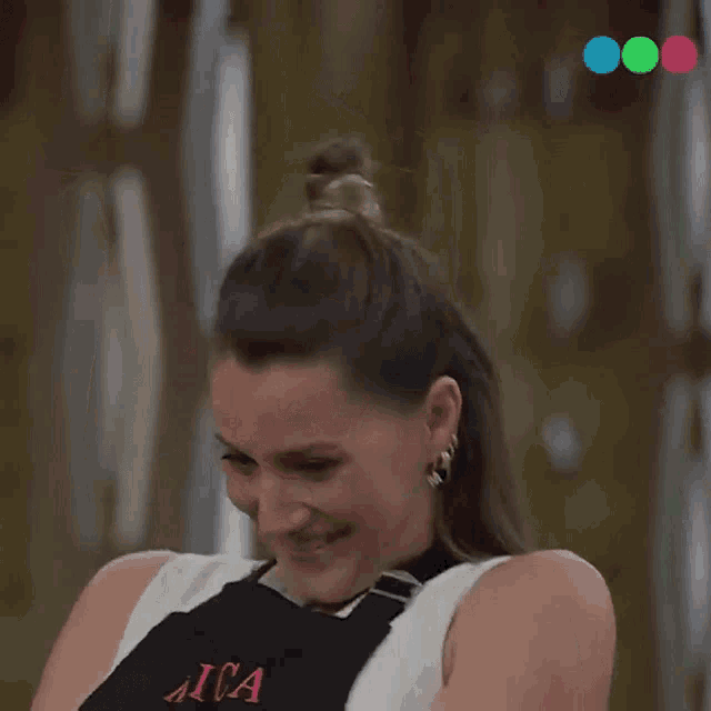 a woman wearing an apron is smiling and clapping