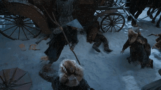 a group of people standing in the snow with a horse drawn carriage behind them