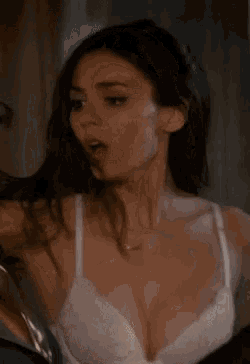 victoria justice is wearing a white bra and looking surprised .