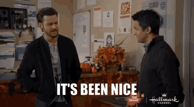 two men are standing next to each other in a room with the words `` it 's been nice '' written on the screen .