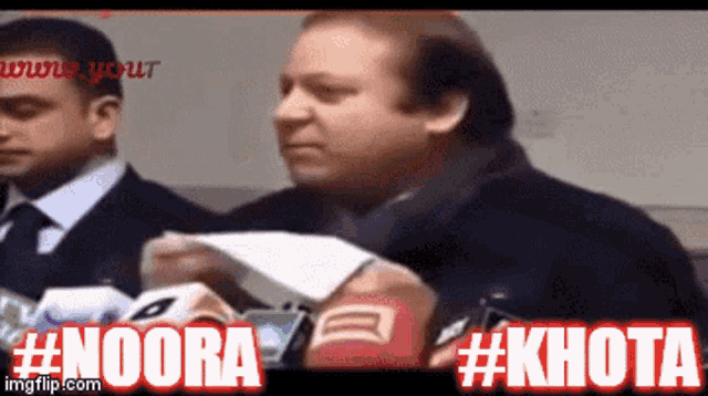 a man holding a piece of paper with the words #noora #khota written on the bottom