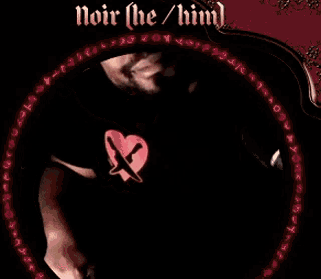 a man in a black shirt with a red heart and the words noir ( he / him )