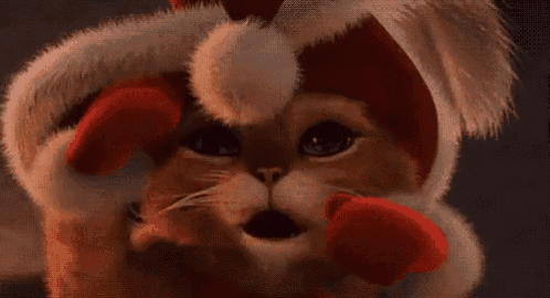 a close up of a stuffed animal wearing a santa hat on its head .