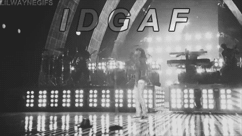 a black and white photo of a woman standing on a stage with the words idgaf written on it
