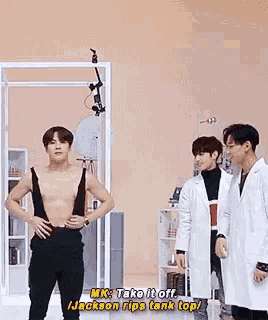 a group of men are standing next to each other in a room .