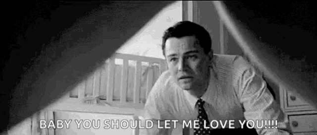 a man in a suit and tie is standing in front of a crib and saying `` baby you should let me love you ! ''