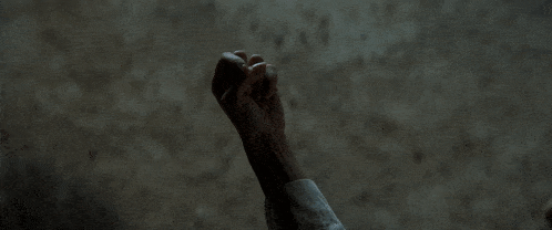 a close up of a person 's hand reaching up into the air