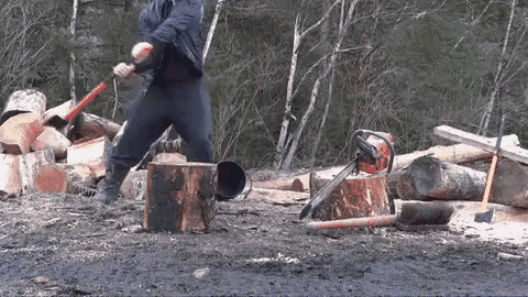 a man is chopping logs with an axe and chainsaw