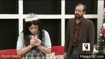 a man in a suit and a woman in a tiara are standing next to each other .