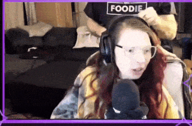 a woman wearing headphones and a shirt that says " foodie "