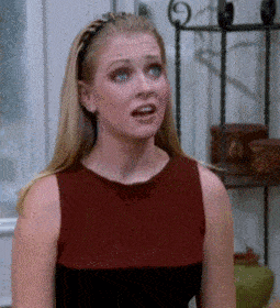 a woman with a braided headband on her head looks surprised