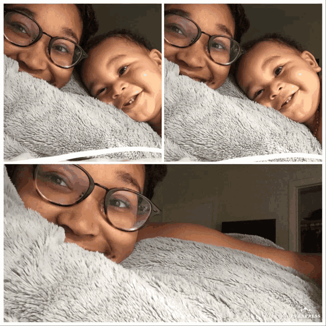 a woman wearing glasses is laying on a blanket with a baby